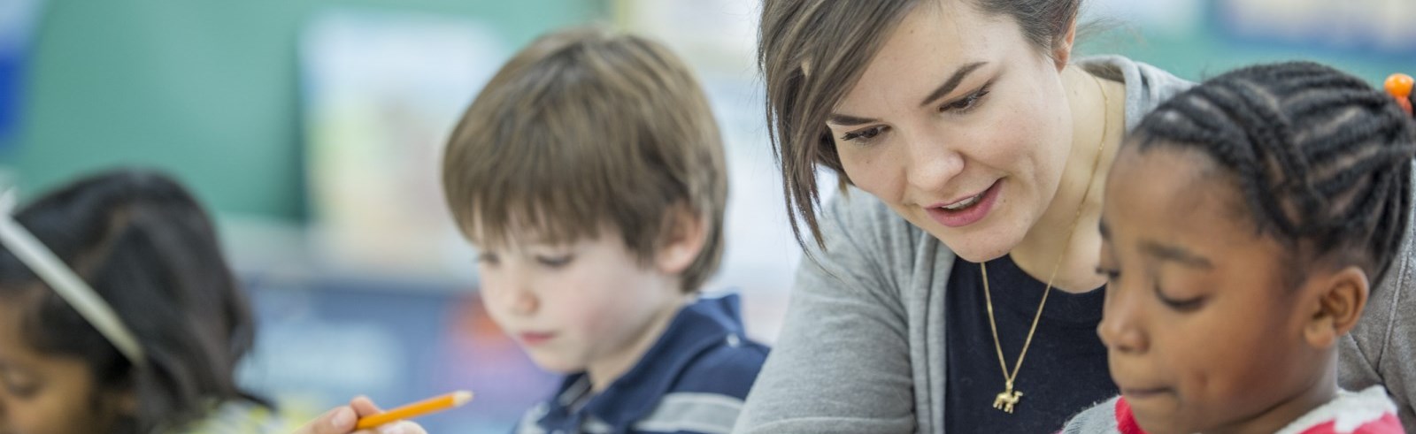 teacher helping child with school work