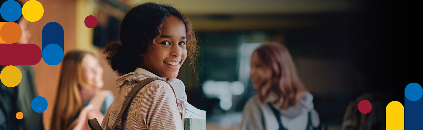 smiling girl looking back with books in hand.